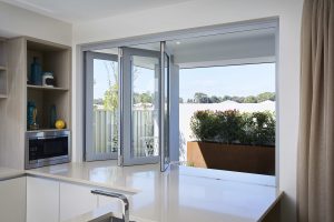 bifold window in kitchen with a view of the backyard