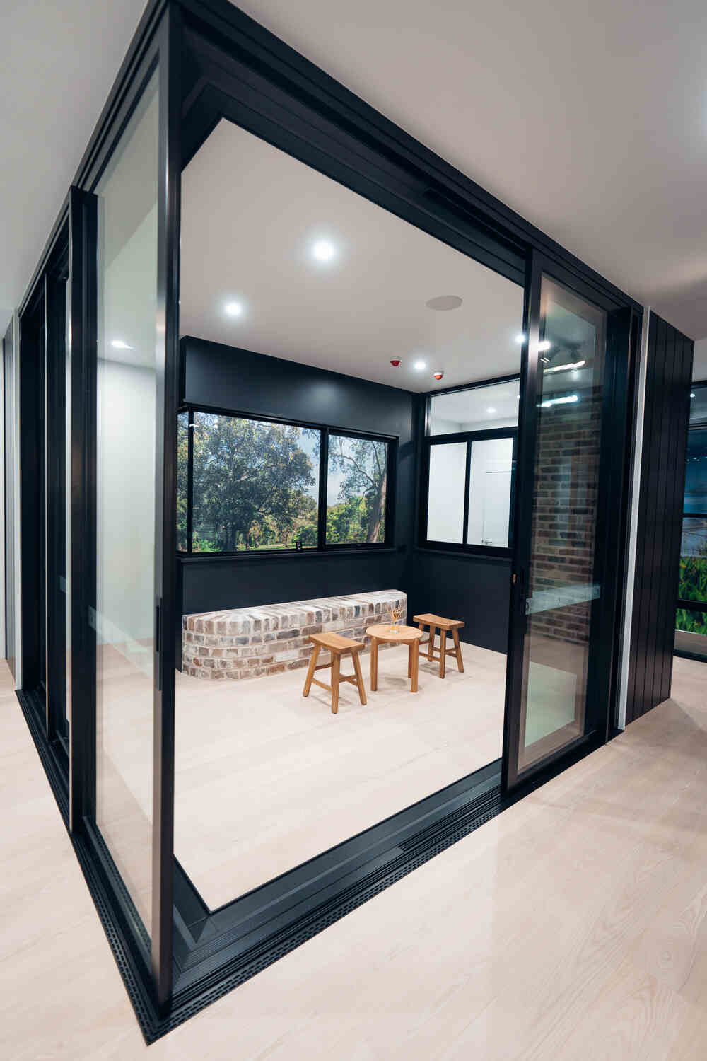 Modern Aluminium Corner Stacking Door Installation with Brick and Glass Interior